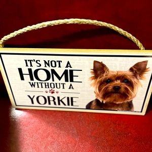 A hanging sign wits a beautiful Yorkie